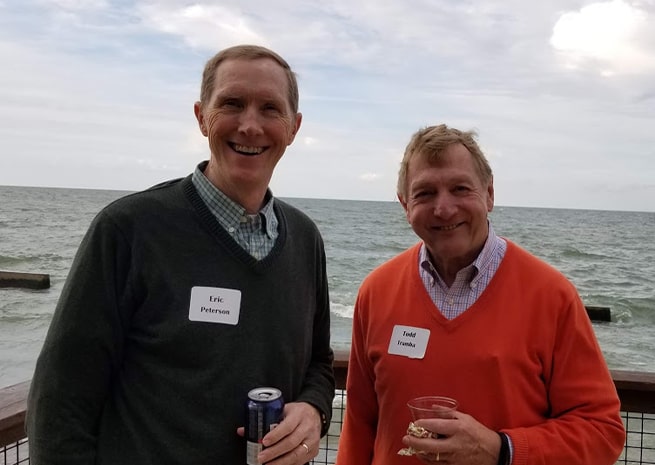 eric peterson and todd tramba pose for a portrait in front of lake erie
